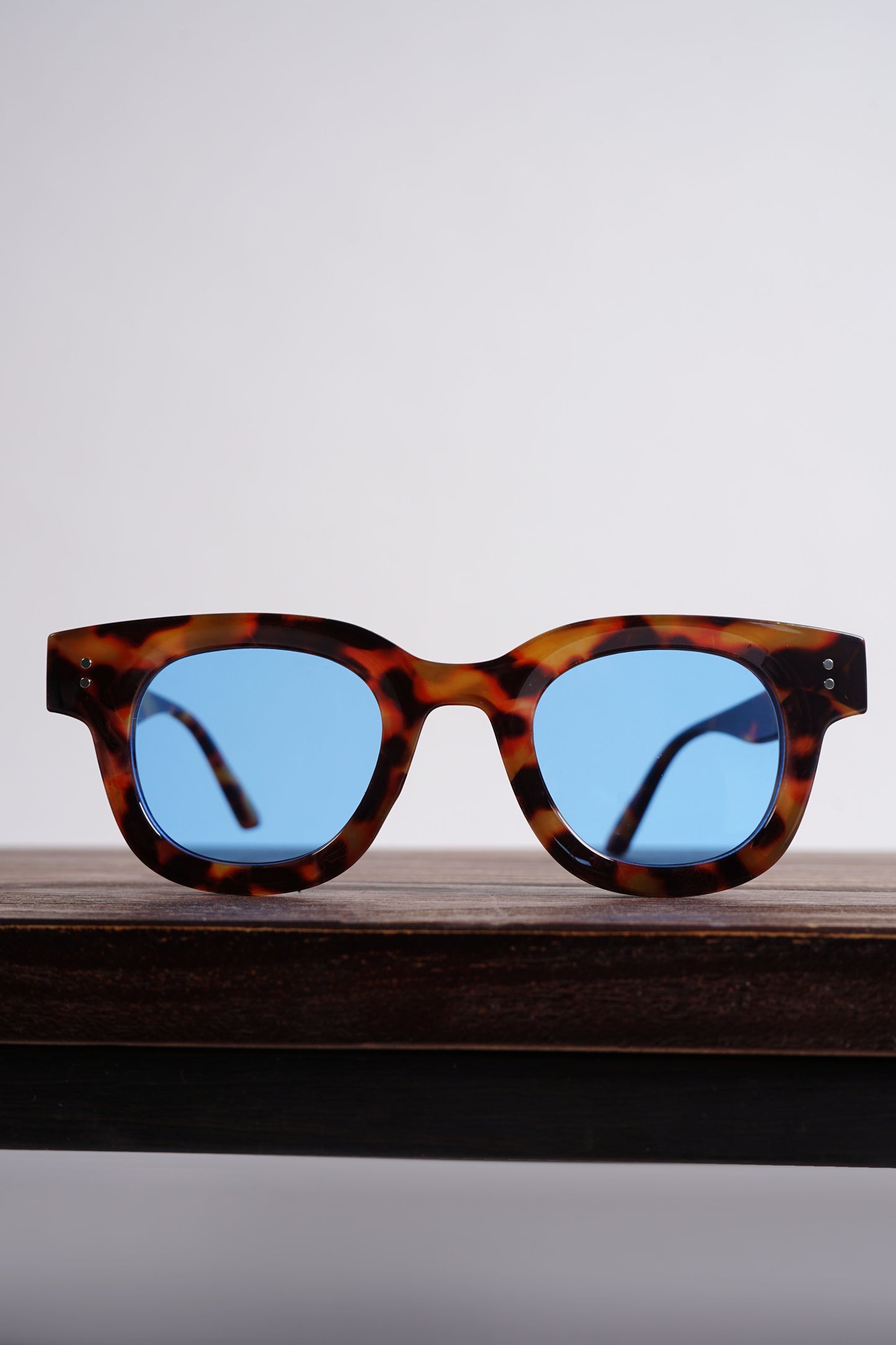 Havana acetate print frame with a blue tinted lens.